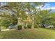 This home boasts a lush front yard with mature trees, providing ample shade and curb appeal at 9332 Leslieshire Dr, Raleigh, NC 27615