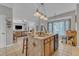 Open concept kitchen with island seating and view of the living room area at 9332 Leslieshire Dr, Raleigh, NC 27615