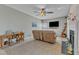 Inviting living room with cozy furniture and a ceiling fan, perfect for relaxation at 9332 Leslieshire Dr, Raleigh, NC 27615