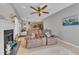 Comfortable living room featuring a fireplace, ceiling fan, and open access to the kitchen at 9332 Leslieshire Dr, Raleigh, NC 27615