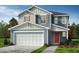 Two-story home showcasing blue siding, white trim, a two-car garage, and a red front door at 952 Emmer St, Rolesville, NC 27571