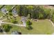 Aerial view of a home with solar panels, spacious yard with a small barn, and partially enclosed area for animals at 10 Gray Bass Ct, Zebulon, NC 27597
