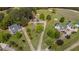 An aerial view showcases homes with long driveways, lush trees, and expansive yards in a neighborhood at 10 Gray Bass Ct, Zebulon, NC 27597