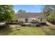 Expansive backyard featuring a wooden deck, perfect for dining, with a well-maintained lawn and privacy fence at 10 Gray Bass Ct, Zebulon, NC 27597