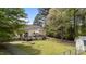 Spacious fenced backyard features a wooden deck with outdoor seating, offering a perfect space for relaxation and entertainment at 10 Gray Bass Ct, Zebulon, NC 27597