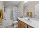 Bathroom with a shower-tub combination, toilet, sink with wood cabinet, and decorative Paris-themed shower curtain at 10 Gray Bass Ct, Zebulon, NC 27597