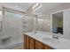 A view of the bathroom with double sinks and walk in tiled shower at 10 Gray Bass Ct, Zebulon, NC 27597