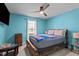 Bright bedroom with a ceiling fan, wooden bedframe, a window, and blue painted walls for a cozy and airy feel at 10 Gray Bass Ct, Zebulon, NC 27597