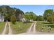 Picturesque property with a long driveway leading to a charming home with a welcoming front porch and well-kept lawn at 10 Gray Bass Ct, Zebulon, NC 27597