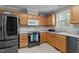 Cozy kitchen with stainless steel appliances, light wood cabinets, a tile backsplash, and a window for natural light at 10 Gray Bass Ct, Zebulon, NC 27597