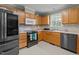 An efficient kitchen features wood cabinets, neutral countertops and backsplash, and modern appliances at 10 Gray Bass Ct, Zebulon, NC 27597