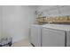 Bright laundry room with white washer and dryer, shelving, and decorative wall border for a clean, organized space at 10 Gray Bass Ct, Zebulon, NC 27597