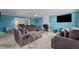 A spacious living room with blue walls, a fireplace, and ample seating on neutral carpet at 10 Gray Bass Ct, Zebulon, NC 27597