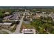 Aerial view of a commercial area with various businesses, parking lots, and lush green trees at 10 Shearin Ln, Youngsville, NC 27596