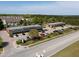 Aerial view of brick commercial buildings with multiple businesses and ample parking spaces on a sunny day at 10 Shearin Ln, Youngsville, NC 27596