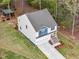 Aerial view of a two-story home, featuring a backyard, two-car garage, and a cozy front porch at 10 Shearin Ln, Youngsville, NC 27596