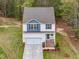 Aerial view of a charming two-story home showcasing a two-car garage and landscaped yard at 10 Shearin Ln, Youngsville, NC 27596