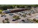 Aerial view of a shopping center with ample parking and a variety of businesses on a sunny day at 10 Shearin Ln, Youngsville, NC 27596