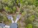 Aerial view of homes nestled among a dense forest canopy in a residential neighborhood at 10 Shearin Ln, Youngsville, NC 27596