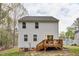 Two-story home with white siding and a wooden deck accessible through sliding glass doors at 10 Shearin Ln, Youngsville, NC 27596