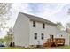 Two-story home with white siding and a wooden deck accessible through sliding glass doors at 10 Shearin Ln, Youngsville, NC 27596