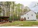 Spacious backyard featuring a two-story home, a wooden deck, and an outdoor seating area at 10 Shearin Ln, Youngsville, NC 27596