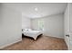 Cozy bedroom with neutral walls, soft carpet, and a comfortable bed next to the window at 10 Shearin Ln, Youngsville, NC 27596