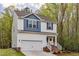 Lovely two-story home featuring a two-car garage, a welcoming front porch, and manicured landscaping at 10 Shearin Ln, Youngsville, NC 27596
