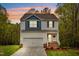 Charming two-story home with a front-facing garage and welcoming front porch at 10 Shearin Ln, Youngsville, NC 27596