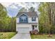 Inviting two-story home with a two-car garage, a cozy porch, and landscaped front yard at 10 Shearin Ln, Youngsville, NC 27596