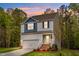 Charming two-story home featuring a garage, front porch and a landscaped front yard at 10 Shearin Ln, Youngsville, NC 27596