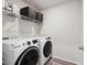 Functional laundry room featuring modern washer and dryer units and storage at 10 Shearin Ln, Youngsville, NC 27596