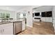 Open-concept living area featuring a modern kitchen and a cozy living room with hardwood floors at 10 Shearin Ln, Youngsville, NC 27596