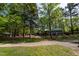 Scenic park view with a playground, picnic area, and walking path amid lush green trees at 10 Shearin Ln, Youngsville, NC 27596
