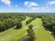 Beautiful aerial view of the golf course with multiple ponds and lush green landscaping at 104 Chuckwagon Dr, Louisburg, NC 27549