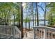 Beautiful lake view from the backyard deck with stairs leading down to the water at 104 Chuckwagon Dr, Louisburg, NC 27549