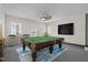 Basement game room with a pool table, bar, and a walkout to the outdoors at 104 Chuckwagon Dr, Louisburg, NC 27549