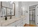 Bathroom with granite countertops, double sinks, and a large framed mirror at 104 Chuckwagon Dr, Louisburg, NC 27549