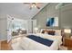 Comfortable bedroom with vaulted ceiling, artwork, and glass paneled doors leading to the sunroom at 104 Chuckwagon Dr, Louisburg, NC 27549