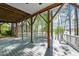 Covered deck with wooden beams, railing, and view of the lake at 104 Chuckwagon Dr, Louisburg, NC 27549