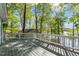 A beautiful outdoor deck with white railings overlooks a lake with many trees at 104 Chuckwagon Dr, Louisburg, NC 27549