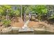 Private dock with chair and lake access in a serene, wooded setting at 104 Chuckwagon Dr, Louisburg, NC 27549