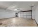 Spacious garage with white walls and door providing ample space for parking and storage at 104 Chuckwagon Dr, Louisburg, NC 27549