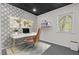 Modern home office with stylish wallpaper, a sleek desk, and a bright window at 104 Chuckwagon Dr, Louisburg, NC 27549