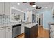 Bright kitchen with white cabinets, granite counters, and stainless steel appliances at 104 Chuckwagon Dr, Louisburg, NC 27549