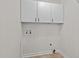 Laundry room with tile flooring, wall mounted cabinets, and washer/dryer hookups at 104 Chuckwagon Dr, Louisburg, NC 27549
