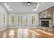 Bright living room featuring a stone fireplace, hardwood floors, and lake views at 104 Chuckwagon Dr, Louisburg, NC 27549