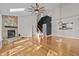 Open-concept living room with hardwood floors, stone fireplace, stairs, and a view into the kitchen at 104 Chuckwagon Dr, Louisburg, NC 27549