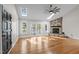 Bright living room with hardwood floors, stone fireplace, skylights, and lake view from sliding glass doors at 104 Chuckwagon Dr, Louisburg, NC 27549