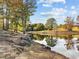 Scenic view of a tranquil pond with trees reflecting off the water at 104 Chuckwagon Dr, Louisburg, NC 27549